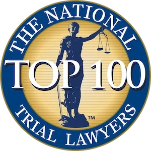 Circular badge with the words "The National Trial Lawyers Top 100" and an image of Lady Justice holding scales in the center, honoring Esq. Dale R. Gomes for exemplary dedication to justice.