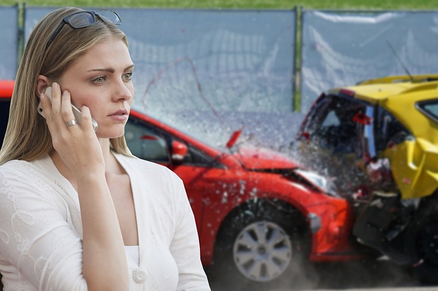 A woman is talking on a phone in the foreground, with two damaged cars from an accident in Sacramento visible behind her.