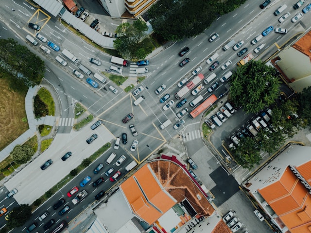 Aerial view of a busy California urban intersection with multiple lanes of cars, crosswalks, nearby buildings, and greenery—where ignition interlock requirements ensure safer roads for everyone.