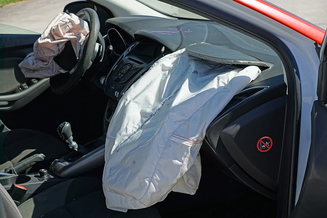 Deployed airbags are visible in the driver and passenger sides of a car's interior, indicating it has been involved in a collision—possibly part of a recent dispute in California.