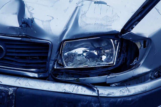 Close-up of a damaged car front, showing a broken headlight, bent hood, and dented bumper after a collision—often seen in incidents involving California DUI or those who dispute breathalyzer results.